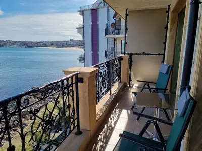 a balcony with chairs and a view of the water at Sea View 2BR Apartment Sozopol in Sozopol