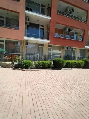 an empty courtyard in front of an apartment building at Сънсет Бийч 3 in Sunny Beach