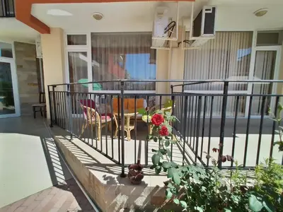 a balcony of a house with a table and chairs at Сънсет Бийч 3 in Sunny Beach