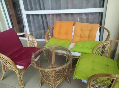 a balcony with chairs and a table and a window at Сънсет Бийч 3 in Sunny Beach