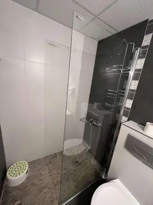a bathroom with a glass shower with a toilet at Bułgaria na lato apartament z widokiem na morze Sozopol in Sozopol