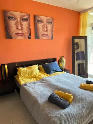 a bedroom with a bed with two posters on the wall at Bułgaria na lato apartament z widokiem na morze Sozopol in Sozopol