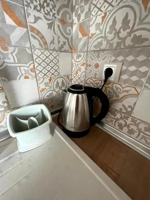 a tea kettle sitting on a counter in a kitchen at Sea Vibes - Modern Apartment Near the Beach & City Center, Burgas in Burgas City