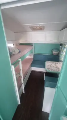 a small room with two bunk beds in a trailer at Каравана Тиана in Sozopol