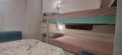 a bedroom with two bunk beds and a bed at Каравана Тиана in Sozopol