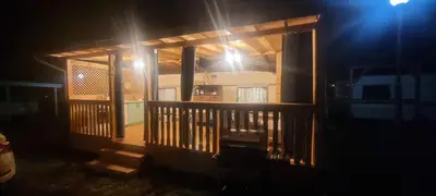 a view of a porch of a house at night at Каравана Тиана in Sozopol