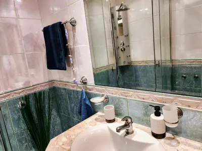 a bathroom with a sink and a mirror at Синьо лято /Blue summer in Sunny Beach