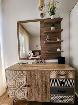 a bathroom with a wooden vanity with a mirror at Синьо лято /Blue summer in Sunny Beach