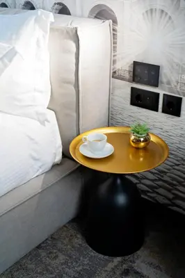 a coffee table sitting next to a couch with a bed at MM Boutique Hotel in Burgas City