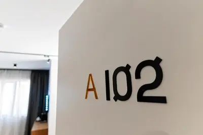 a sign on a wall with a on it at MM Boutique Hotel in Burgas City