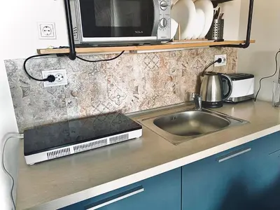 a kitchen counter with a sink and a microwave at Design Studio in Atlantis Resort&SPA, Burgas Airport in Burgas City