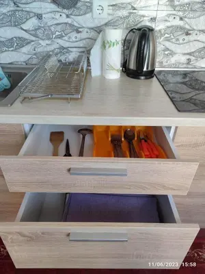 a drawer in a cabinet filled with cooking utensils at Apartament Piero in Pomorie