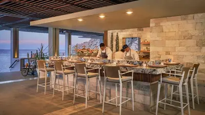 two people standing at a bar in a restaurant at SIANA4 in Sveti Vlas