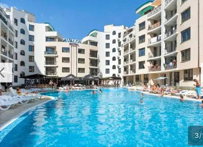 a swimming pool in a resort with people in it at AVALON, Apartment C102 in Sunny Beach