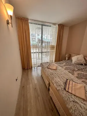 a bedroom with two beds and a large window at AVALON, Apartment C102 in Sunny Beach