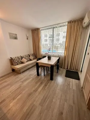 a living room with a couch and a table at AVALON, Apartment C102 in Sunny Beach