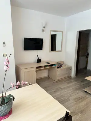 a living room with a television and a table at AVALON, Apartment C102 in Sunny Beach