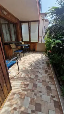 a patio with a table and chairs on a building at Цар Калоян in Primorsko