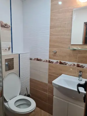a bathroom with a toilet and a sink at Цар Калоян in Primorsko