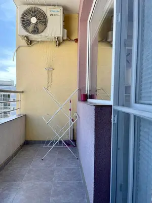 a balcony with a heater and a fan at Апартамент Чаролит / Apartment Charoite in Burgas City