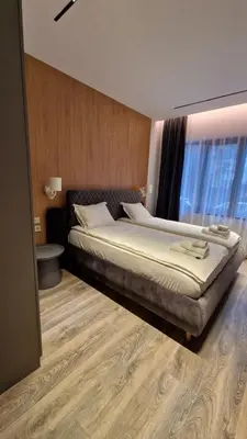 a bedroom with a large bed and a window at FS Apartments - Family apartment in the top center of Varna in Varna City