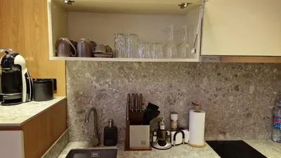 a kitchen with a sink and some glasses on a counter at FS Apartments - Family apartment in the top center of Varna in Varna City
