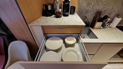 a small kitchen with a sink and white plates at FS Apartments - Family apartment in the top center of Varna in Varna City