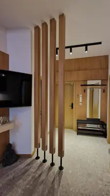 a room with wooden dividers in a room with a piano at FS Apartments - Family apartment in the top center of Varna in Varna City
