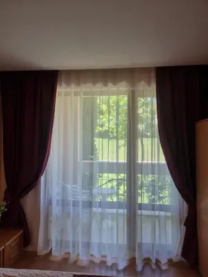 a window with white curtains in a room at Prestige Fort Beach apartment, Studio in Sveti Vlas