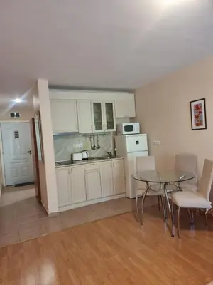 a kitchen and dining room with a table and chairs at Prestige Fort Beach apartment, Studio in Sveti Vlas