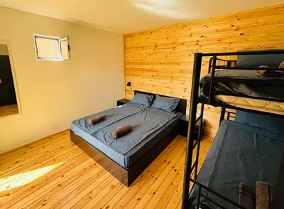 a bedroom with a bunk bed and two bunk beds at CozyHut Бунгало под Наем in Chernomorets