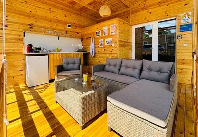 a living room with a couch and a table at CozyHut Бунгало под Наем in Chernomorets