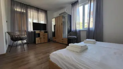 a bedroom with a bed with two white towels on it at Q Аpartment in Tsarevo