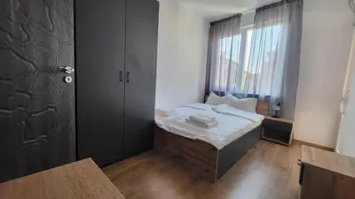 a small bedroom with a bed and a window at Q Аpartment in Tsarevo