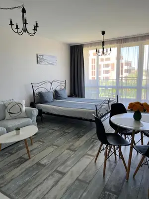 a bedroom with a bed and a couch and tables at Studio E32 Atia Resort Chernomoretz in Chernomorets