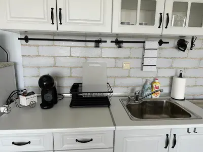 a kitchen counter with a sink and a laptop at Studio E32 Atia Resort Chernomoretz in Chernomorets