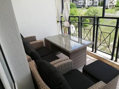 a table and chairs on a balcony with a view at Ferienwohnung mit Meerblick! in Sveti Vlas
