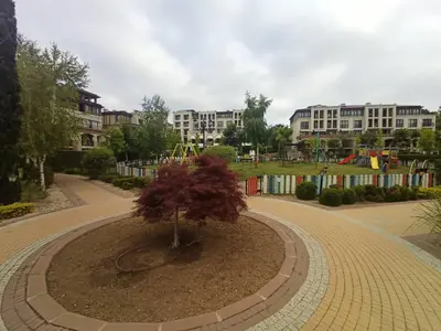 a small tree in a circle in a park at Апартамент Blue в местност Каваци, Созопол in Sozopol