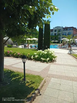 a parking meter in a park with a swimming pool at Апартамент Blue в местност Каваци, Созопол in Sozopol