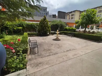 a park with a fire hydrant and benches and flowers at Апартхотел Роял Дриймс in Sunny Beach