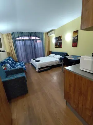 a living room with a bed and a couch at Апартхотел Роял Дриймс in Sunny Beach