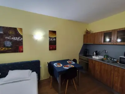 a small kitchen with a small table in a room at Апартхотел Роял Дриймс in Sunny Beach