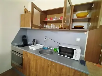 a kitchen counter with a sink and a microwave at Апартхотел Роял Дриймс in Sunny Beach
