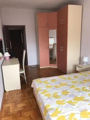 a bedroom with a bed and a table and a desk at Star Ray Apartment in Varna City