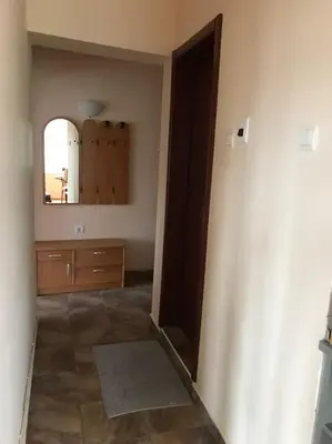 a room with a hallway with a mirror and a dresser at Star Ray Apartment in Varna City