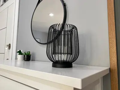 a black vase on a white counter in a bathroom at Студио Ирма in Burgas City