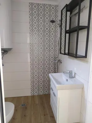 a bathroom with a sink and a toilet and a mirror at Студио Ирма in Burgas City
