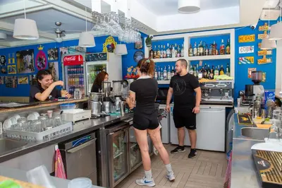 a group of people standing at the counter of a bar at TSB Roxy Apartments in Sunny Beach