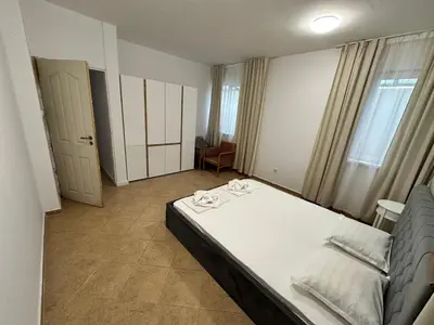 a bedroom with a bed with two towels on it at Horizont Apartments in Sunny Beach