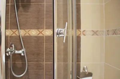 a shower in a bathroom with a glass door at Horizont Apartments in Sunny Beach